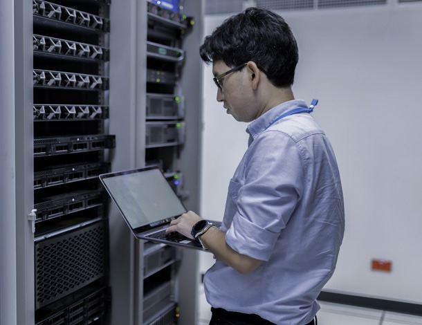 A smiling IT professional with a headset